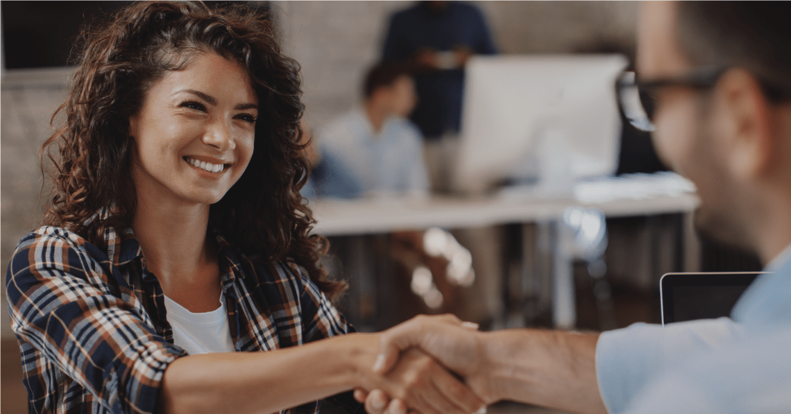 Woman shaking a man's hand